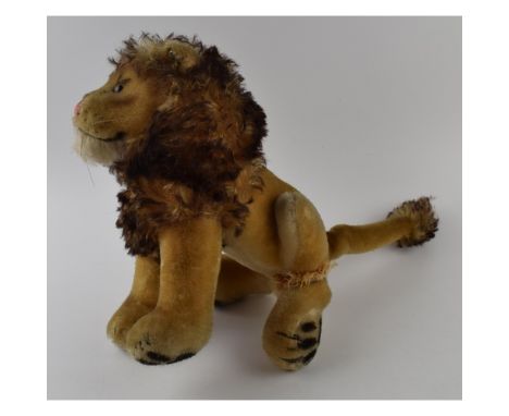 Vintage Steiff straw-filled male lion. Height 27cm.  Damage to rear left leg.