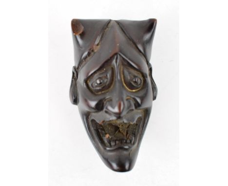 A hardwood hand carved Netsuke in the form of a horned demonic /devil figure. Buddhist or Daoist of oriental origin. Likely e