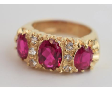 9ct gold dress ring, 4 red stones and 6 smaller white stones, wide shank, 7.1 grams, size K.  