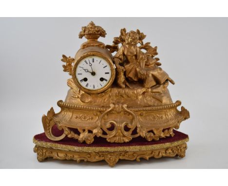19th century gilt French ormolu clock on wooden gilt base with velvet lining, 38cm wide, with key and pendulum.  Sold as need
