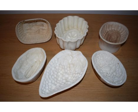 A collection of early to mid 19th century creamware jelly moulds to include makes such as Wedgwood, Spode and Copeland with a