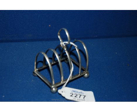 A Silver Toast Rack, London 1908, maker W.H.C. Ltd. and a Sheffield Silver 1898 Ladle