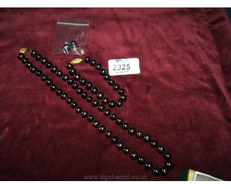 A Black cultured Pearl Necklace, bracelet and earrings set.