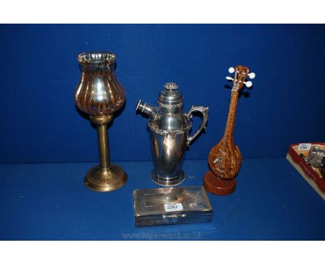 A silver plated Cocktail Jug with inscription, brass candlestick and plated Cigarette Box.
