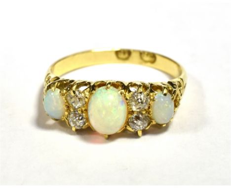 LATE 19th/20th CENTURY 18CT OPAL AND OLD CUT DIAMOND DRESS RING Central Opal Oval 6 x 5mm approx, two outer Opals 4 x 3mm app