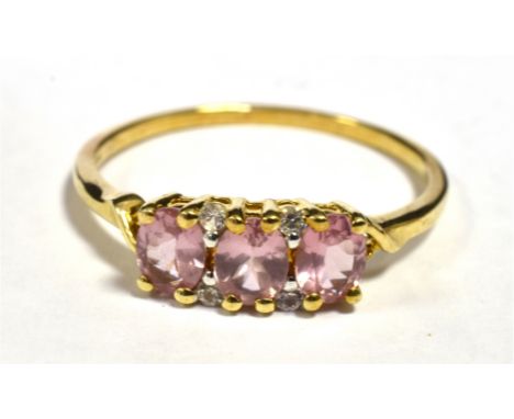 10KT PINK SAPPHIRE, THREE STONE DRESS RING Shank marked 417 10KT, Ring size U, Weight 2g