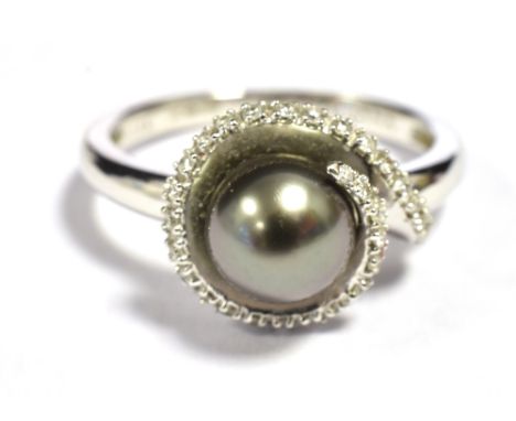 ILIANA 18K WHITE GOLD, BLACK PEARL DRESS RING The pearl measuring 7mm in diameter with a wrap over halo of clear stone accent