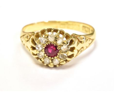 EARLY 20TH CENTURY, 18CT GOLD, OLD CUT DIAMOND AND RUBY CLUSTER RING. The cluster centrally set with a small round cut Ruby s
