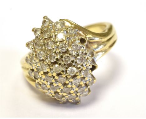 9CT GOLD DIAMOND CLUSTER RING The domed cluster set with numerous tiny diamonds in white metal on a yellow gold band marked 9
