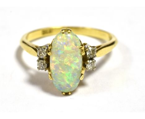 EARLY 20TH CENTURY 18CT OPAL AND OLD CUT DIAMOND COCKTAIL RING The Navette/Oval shaped Opal measuring 12 x 6mm and flanked ea