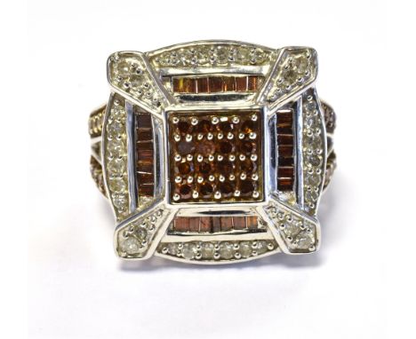 TGGC 417 10K DIAMOND SET STATEMENT RING The head set with diamond accents and orange stone accents in white metal. Ring size 