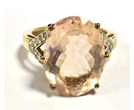 9CT GOLD MORGANITE AND DIAMOND COCKTAIL RING The Oval faceted Morganite measuring 15mm x 11mm with split diamond set shoulder