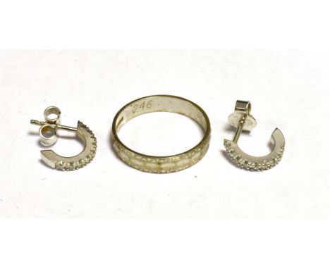 18CT WHITE GOLD PATTERNED BAND RING Together with a pair of stamped 750 White metal diamond set half hoop stud earrings (leng