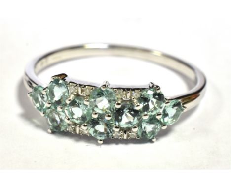 9KT WHITE GOLD AQUAMARINE CLUSTER RING. The ring set with 10 small round cut aquamarines with white stone accents. Ring size 