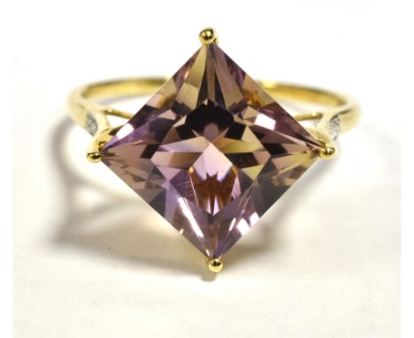 10KT AMETHYST COCKTAIL RING The faceted lozenge cut amethyst measuring 15 x 15mm with diamond accent shoulders. Shank marked 