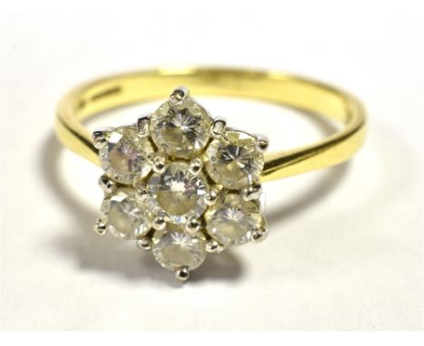 DIAMOND FLOWER HEAD RING The Flower head set with seven round cut diamonds each measuring approx 3mm in diameter, flower head