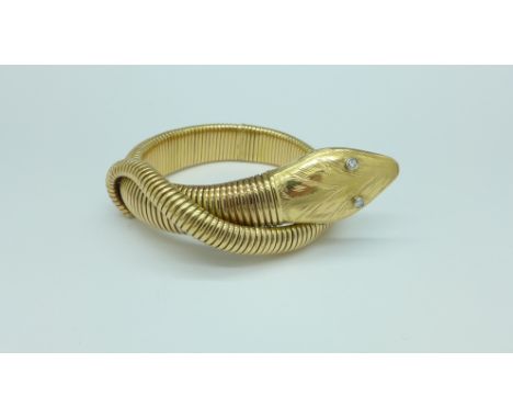 A flexible yellow metal snake bangle with diamond set eyes, 48g, width of head 19mm, requires small repair, (head should be a