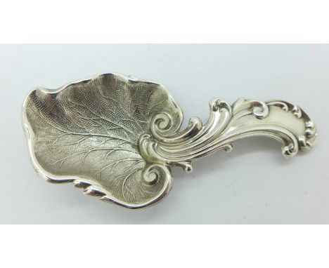 A Victorian silver repousse style caddy spoon