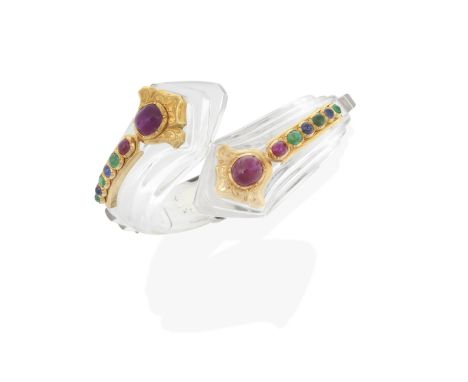 CARTIER: ART DECO GEM-SET ROCK CRYSTAL BANGLE, CIRCA 1930Each ruby cabochon within an engraved mount of Persian inspiration, 
