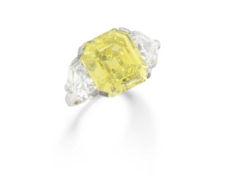 DIAMOND AND COLOURED DIAMOND RINGThe step-cut diamond of Fancy Intense Yellow colour, weighing 10.01 carats, between shield-c