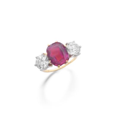 RUBY AND DIAMOND RINGThe  cushion-shaped ruby, weighing 7.10 carats, between old brilliant-cut diamonds, diamonds approximate
