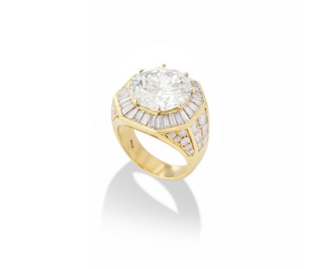 DIAMOND DRESS RINGThe brilliant-cut diamond, weighing 9.39 carats, within a surround of tapered baguette-cut diamonds, betwee