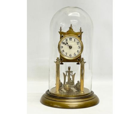 An early 20th century brass Anniversary clock with glass dome. 32cm 
