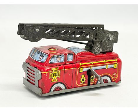 A vintage tinplate windup Yone fire engine. Made in Japan. 10cm closed. 