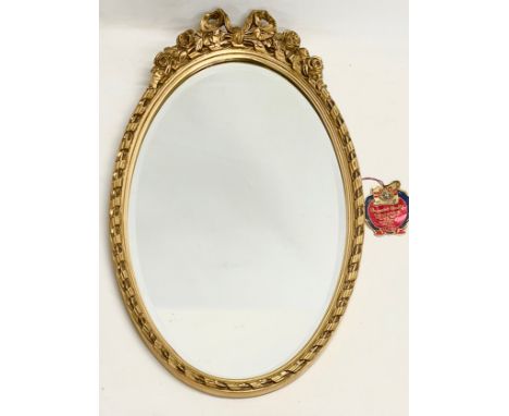 A vintage ornate gilt framed bevelled mirror. 37x62cm 