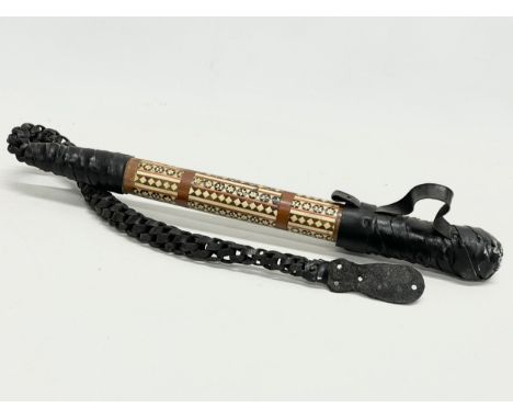 A vintage inlaid camel whip with hidden stiletto knife. 83cm total. 
