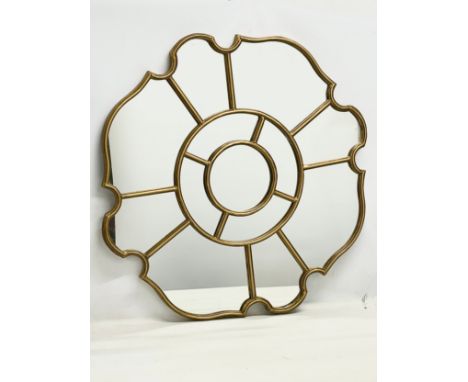 A large ornate brass framed mirror. 88cm