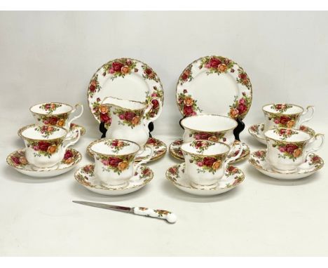 A 21 piece Royal Albert Old Country Roses tea set. 6 sandwich plates, a knife, 6 cups, 6 saucers, milk jug and sugar bowl. 