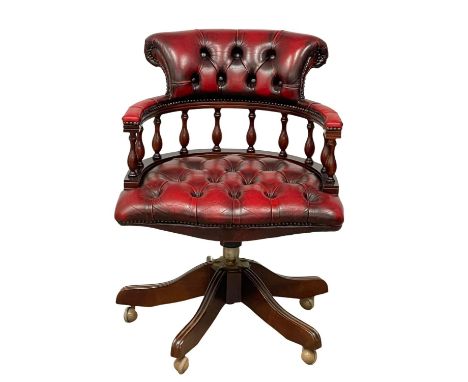 A vintage deep button ox-blood leather swivel captains desk chair 