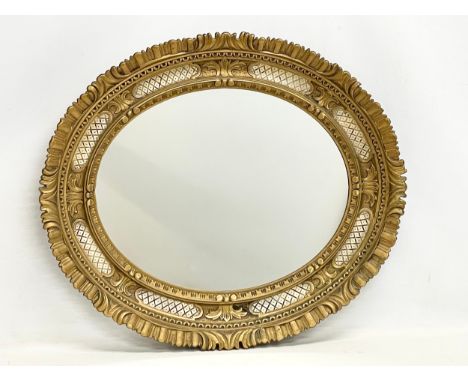 A vintage ornate framed mirror. Plastic. 70x69cm 