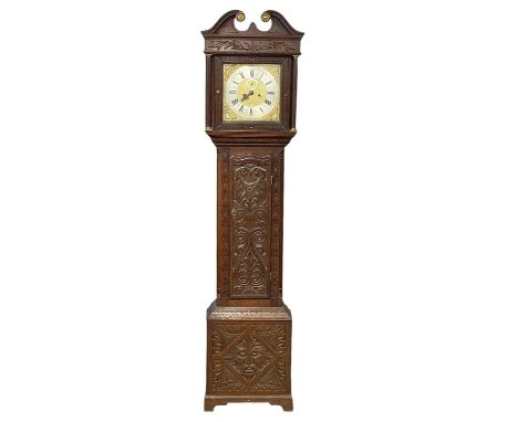 A late 17th century long case clock movement with brass and steel face by Henry Massy with a 19th century carved oak case. We