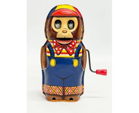 A vintage tinplate windup monkey. Made in Japan. 14.5cm 