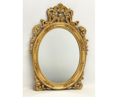 An ornate gilt framed mirror. 37x54cm 