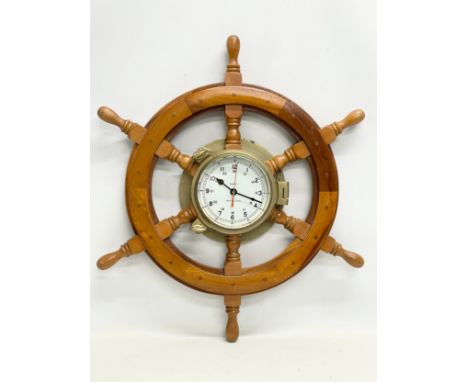 A vintage ships wheel style wall clock. 63cm 