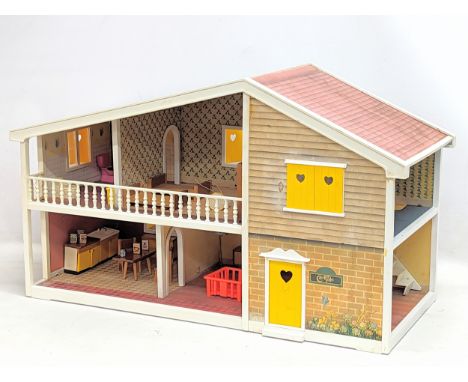 A vintage Barton Toys dolls house, 'Caroline's Home.' 69x29x40cm 