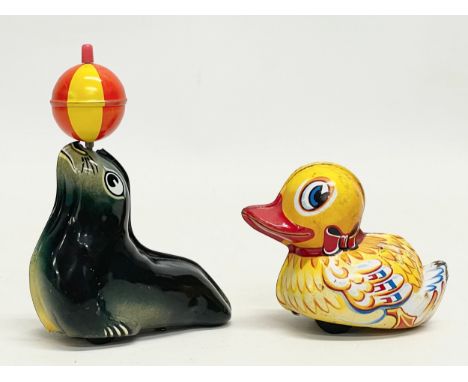 2 vintage Lehmann tinplate toys. An AHA 910 balancing seal. A Paak-Paak 903 Duck. Made in West Germany. Seal 8x10cm 