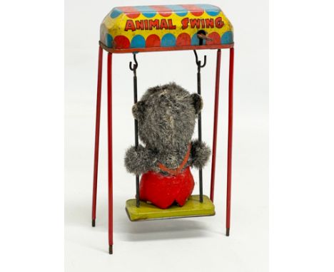 A vintage tin plate ‘Animal Swing’ windup toy. Made in Japan. 18.5cm 