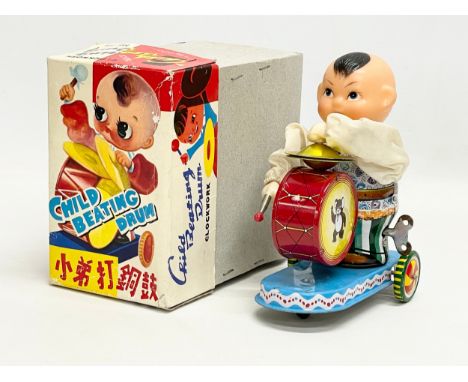 A vintage tinplate windup ‘Child Beating Drum’ in original box. Box measures 14x9x16cm. 