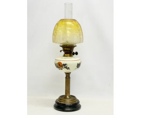 A large Victorian double burner oil lamp with etch yellow glass shade. 67cm 