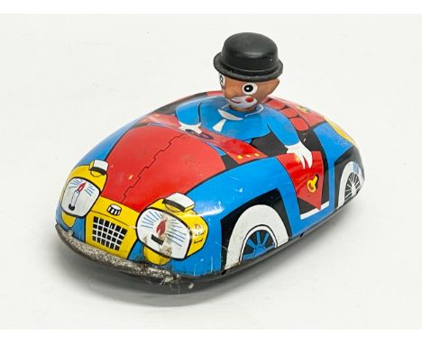 A vintage tinplate windup clown bumper car. 16x8cm 