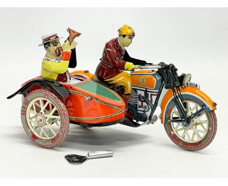 A vintage tinplate windup Paya motorcycle and sidecar. 18cm 