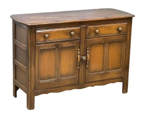 An Ercol Windsor Mid Century sideboard.  123x48x85cm 