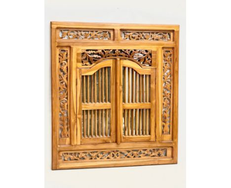 A carved teak framed mirror with doors.  80x89.5cm 