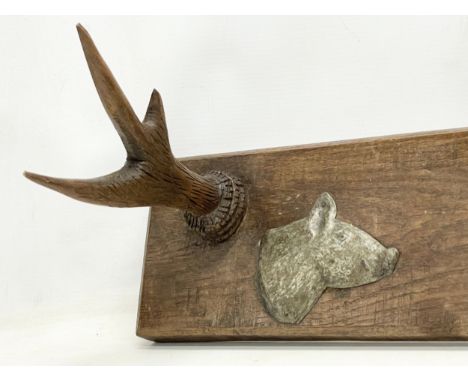 An early 20th century Hunting Lodge coat rack with pewter plaques of dog and boar. 60x14x26cm. 
