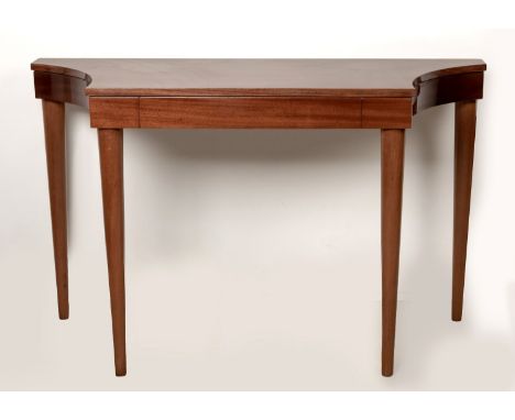 A MAHOGANY CONSOLE TABLE, MANUFACTURED BY PIERRE CRONJEThe scalloped top above a plain frieze, on turned tapering legs 87,5cm