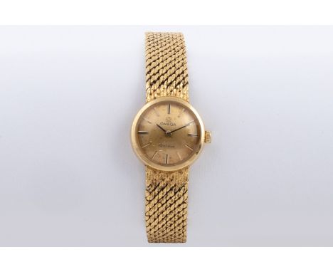 Manual, the circular champagne-coloured dial with gilt and black enamel baton markers, on an integral mesh strap with texture